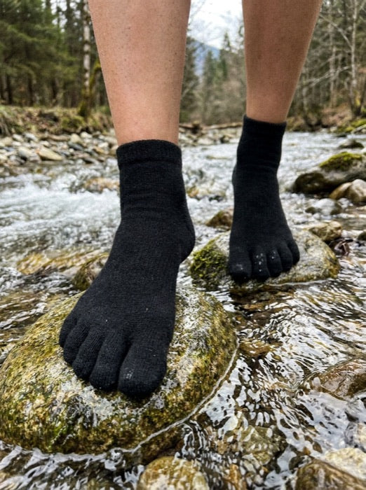 Customer wearing Kaido toe socks by a mountain stream