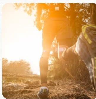 Runner on a trail at sunset