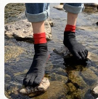 Feet in Kaido toe socks crossing a stream